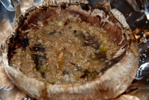 A portobello mushroom cap turned upside down filled with the shallot mixture.
