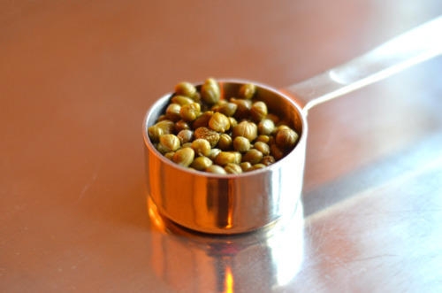 Capers in a measuring cup.