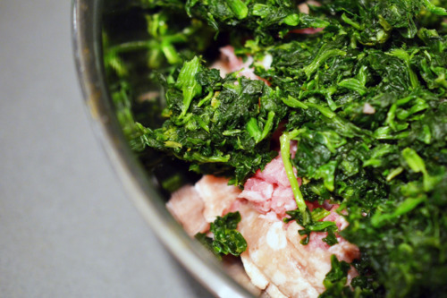 Defrosted spinach. in a bowl with the ground pork for the pork sliders.